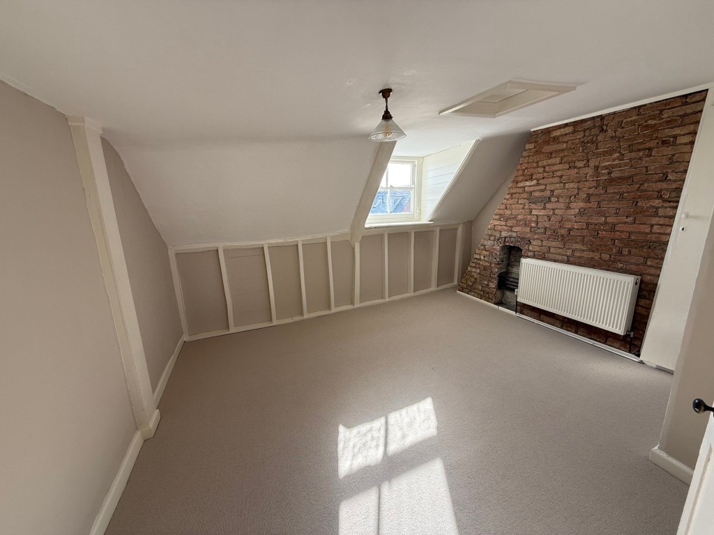 Lot: 81 - FREEHOLD INVESTMENT - Bedroom with exposed brick chimney breast